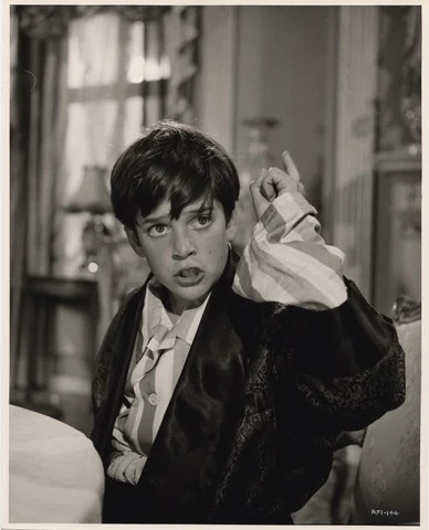 مايكل تشابلن في دور روبرت ماكابي في A King in New York (1957): يصبح الضغط السياسي على الطفل وعائلته جزءًا مباشرًا من الحكاية.